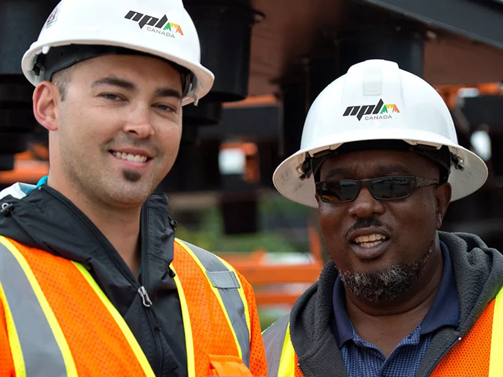 Two construction workers smiling