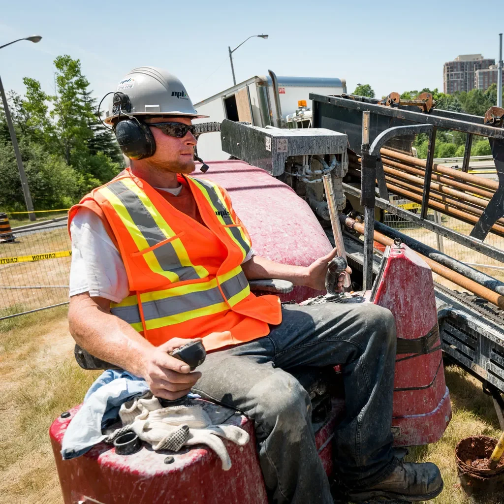 Construction worker sitting on construction vehicle